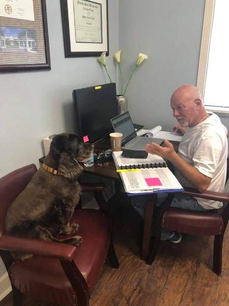 John consulting with his dog